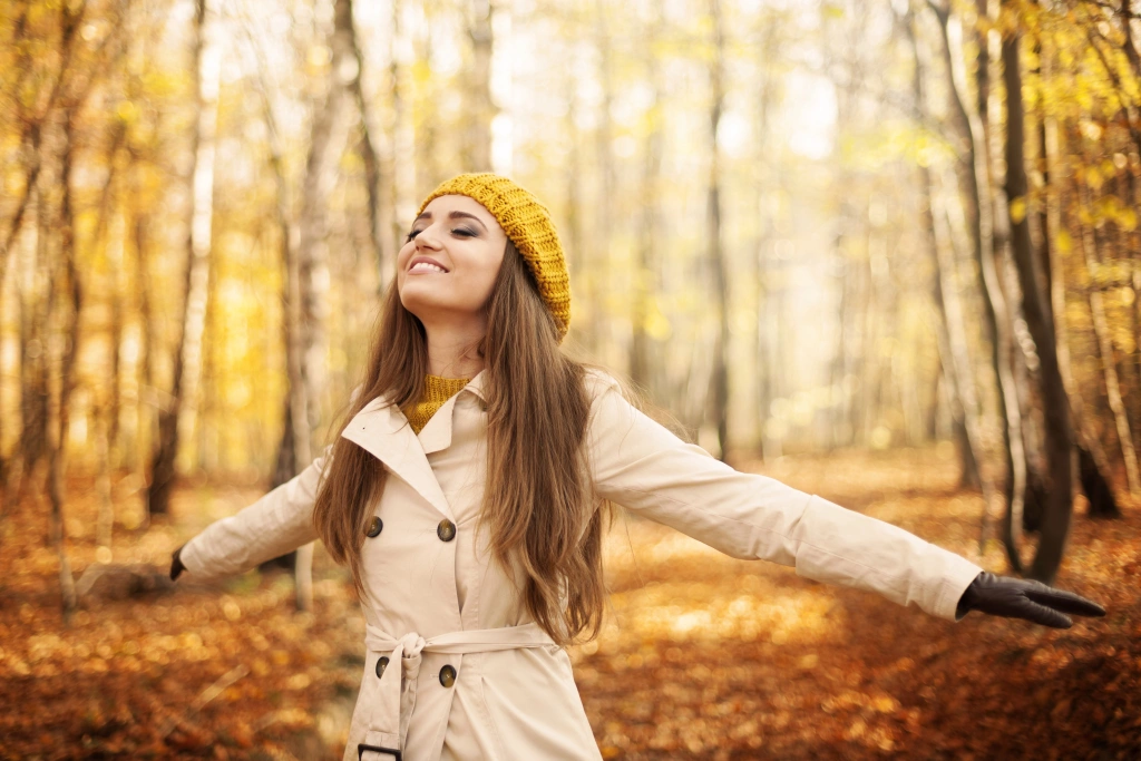 young-woman-enjoying-nature-autumn.webp